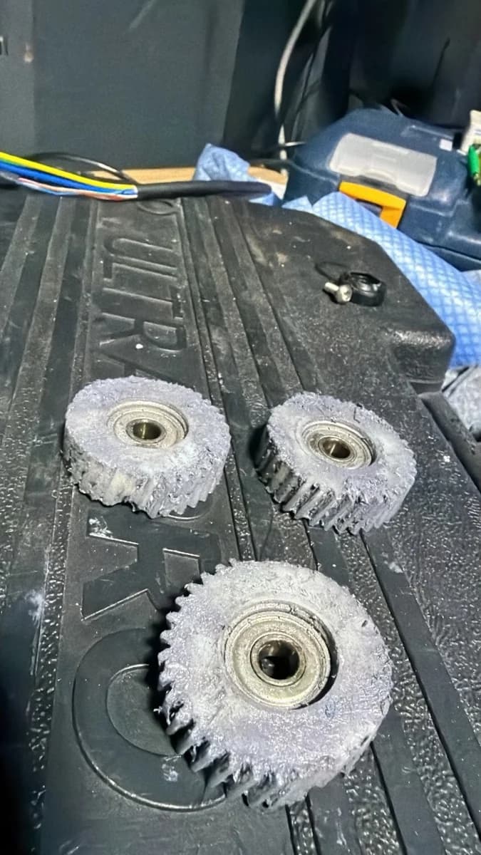 Three worn planetary gears removed from a serviceable e-bike hub motor at Sprocket Science
