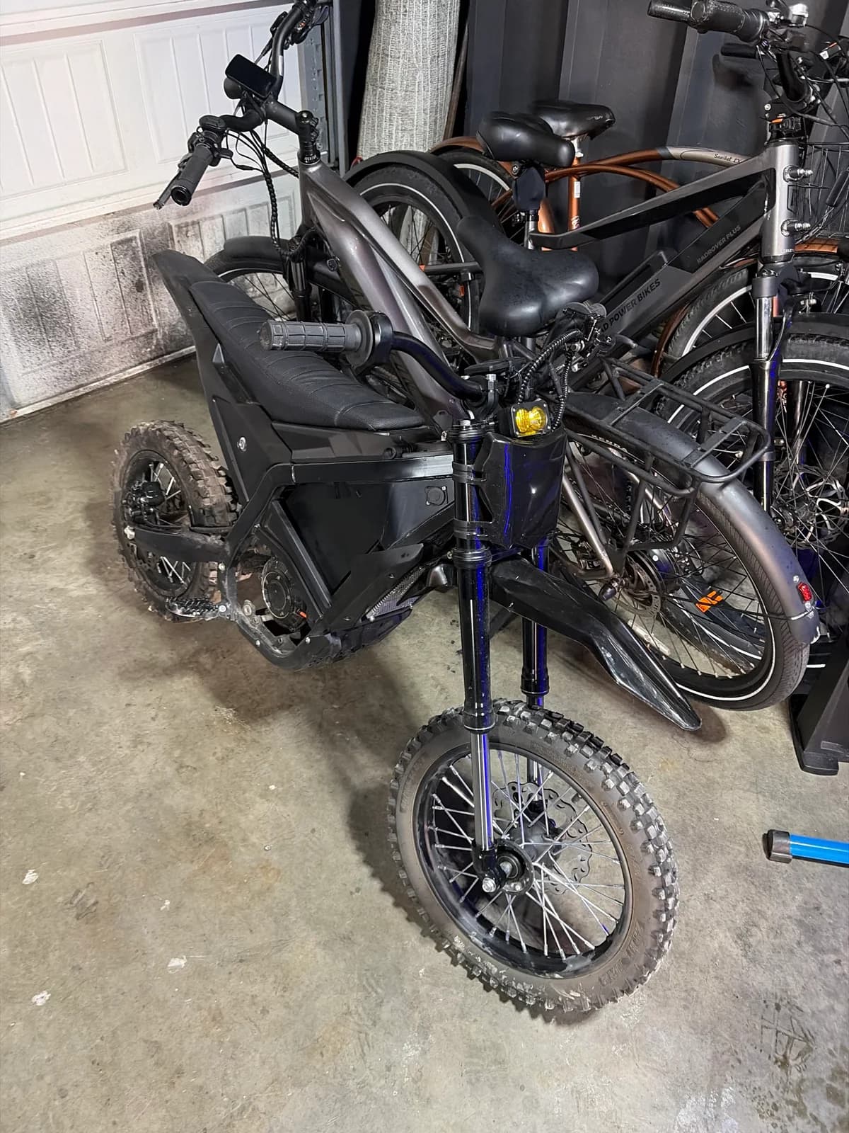 A real electric mini-moto at Sprocket Science with e-bikes visible behind it