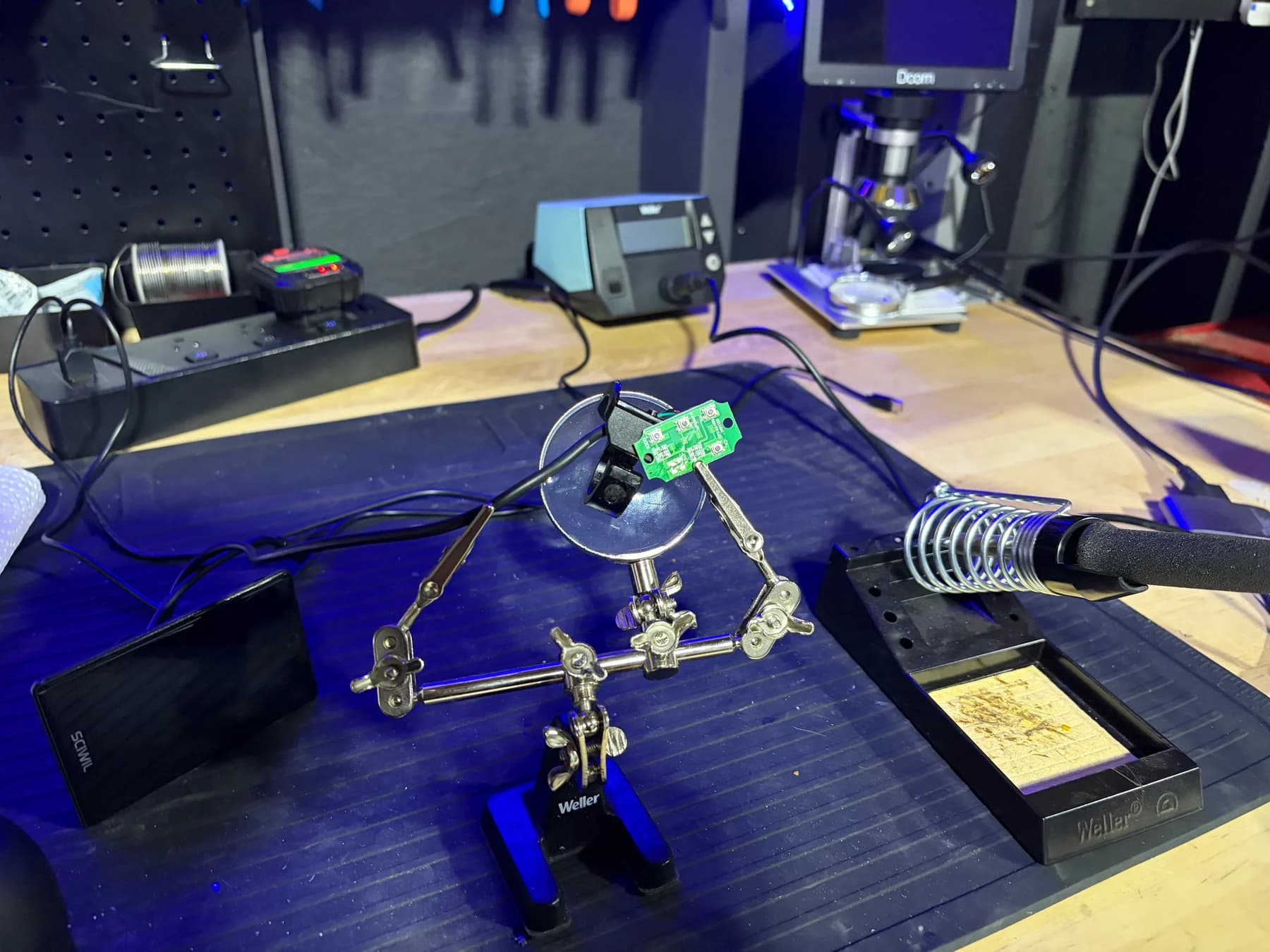 A small electric-mobility control board held for close inspection at the Sprocket Science electronics bench